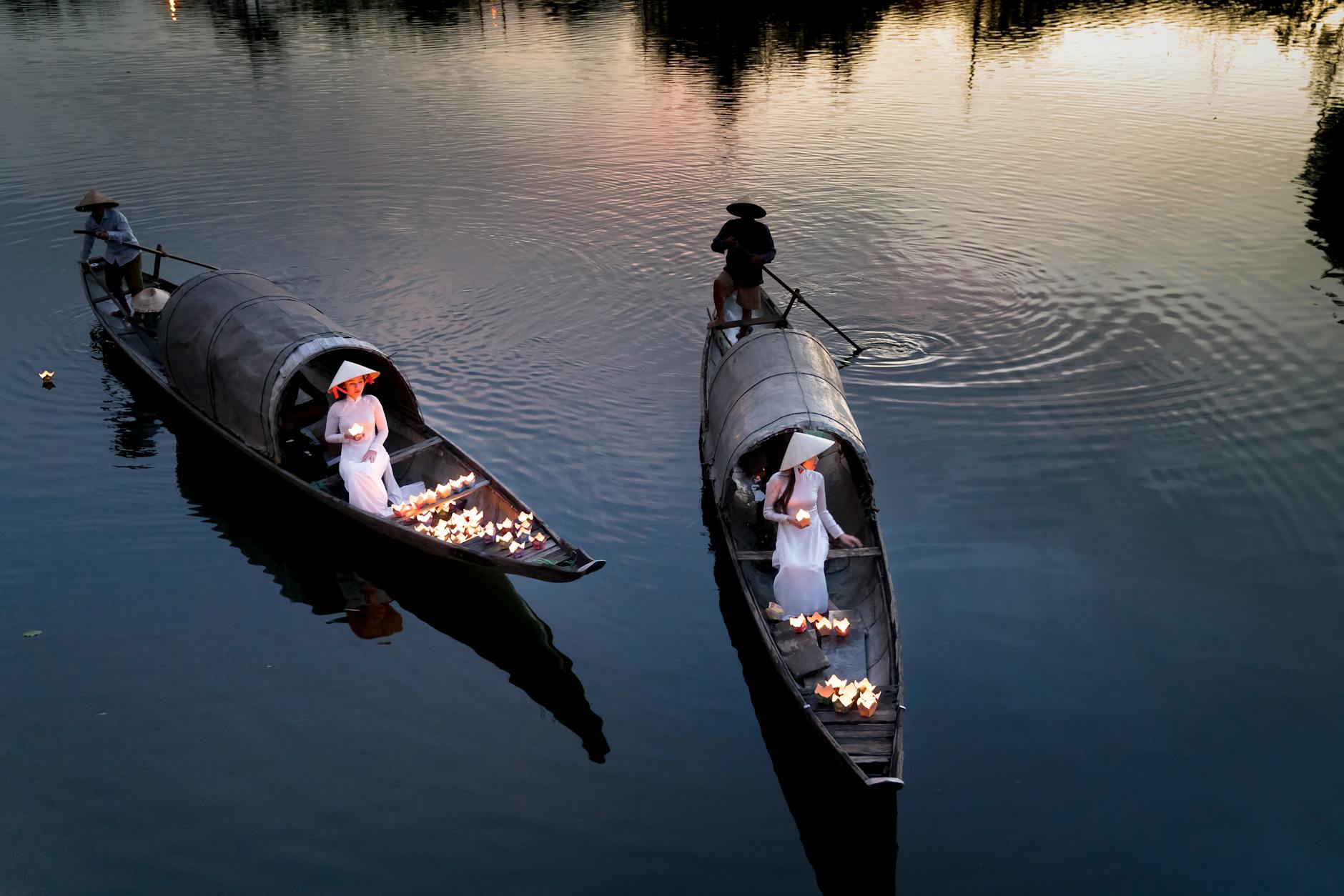 four person using two boats on calm sea